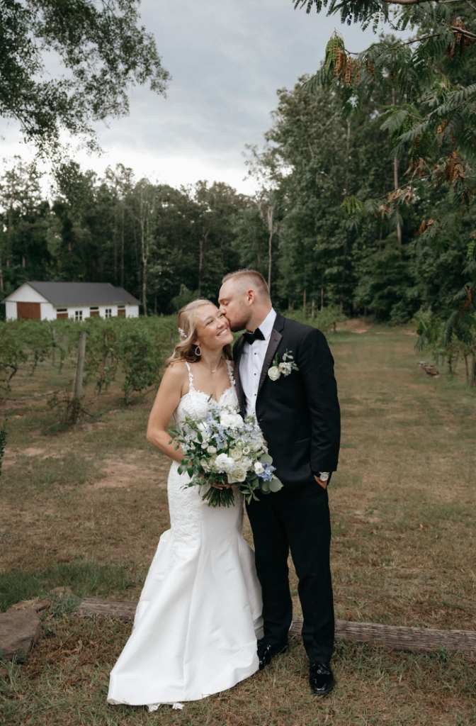 Bride and groom walking amongst the vineyards at Koury Farms